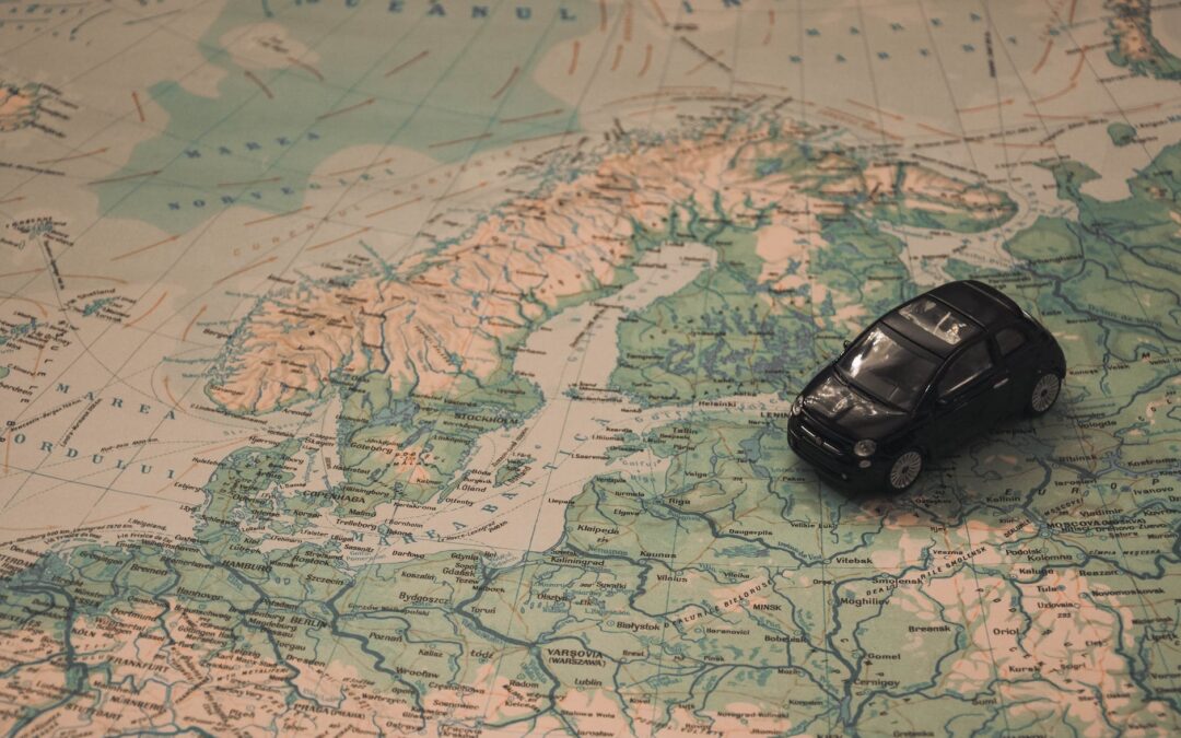 black toy car on world map paper